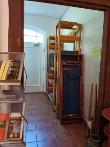 a room with a room with shelves and a door at Ferien am Schloss - Wohnung 5 "der Hahn", Ferienwohnung am Badesee in Behren-Lübchin