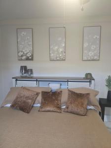 a bed with four pillows on it in a bedroom at Welcome to this romantic getaway in Sarasota