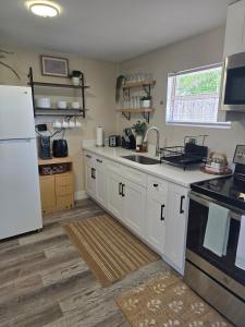a kitchen with white cabinets and a white refrigerator at Welcome to this romantic getaway in Sarasota