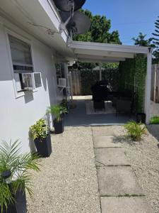 a patio with potted plants on the side of a house at Welcome to this romantic getaway in Sarasota
