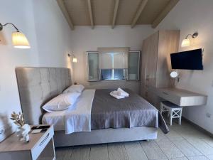 a bedroom with a bed and a desk and a sink at Kea Harbor 2 in Korissia