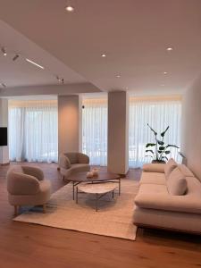 a living room with two couches and a table at Hotel Leone in Međugorje