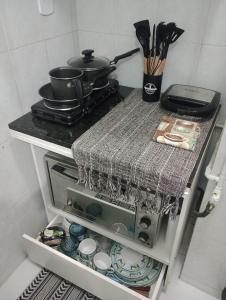 a small kitchen with a stove and some utensils at Apto Turismo da Serra in Teresópolis +17 photos