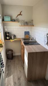 a kitchen with a sink and a counter top at Ferienwohnung in Zirchow