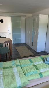 a bedroom with a bed and a table and a desk at Ferienwohnung in Zirchow +1 photo