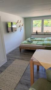 a living room with two beds and a table at Ferienwohnung in Zirchow
