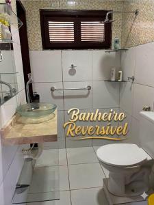 a bathroom with a sink and a toilet at Paracuru Praia in Paracuru +14 photos