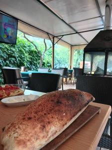 a large calzone sitting on a table in a restaurant at Kalinka pansiyon in Cıralı +25 photos