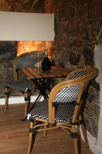 two chairs and a wooden table with a vase on it at Aprosmeno House 5 in Agros +9 photos