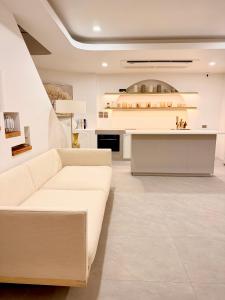 a living room with a white couch and a kitchen at CASA MARINe in Bophut +37 photos