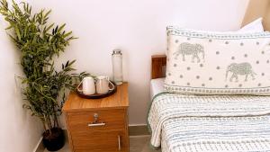 a bedroom with a bed with a pillow and a night stand at Gypsy Walker in Varkala