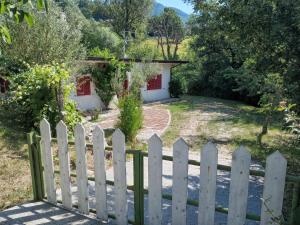 a white picket fence in front of a house at Fosso Marchese in Cusano Mutri +2 photos