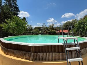 a chair sitting in front of a swimming pool at Antiche Dimore Del Vescovado in Siena