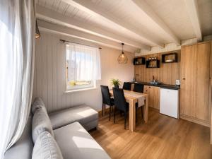 a living room with a couch and a table at Eden Apartament-Jacuzzi, sauna in Jastrzębia Góra