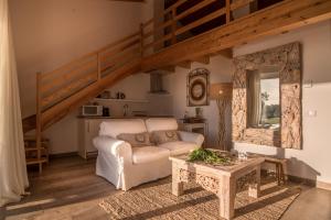 a living room with a couch and a table at Monte do Cardal in Odeceixe