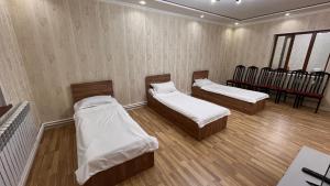 a room with three beds and a piano at DARAI guest house Hostel Turkistan in Türkistan +20 photos