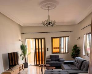 a living room with a couch and a table at Chez Gero Aeroport in Cotonou