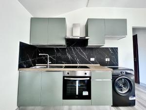 a kitchen with a sink and a washing machine at Moderno Bilocale Bresso in Bresso