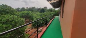 a balcony of a train with a green floor at Nature Nest In in Auroville