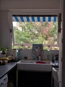 a kitchen with a sink and a window at Appartement,clair au calme avec balcon in Fontenay-sous-Bois