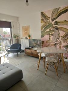 a living room with a table and a couch at Appartement,clair au calme avec balcon in Fontenay-sous-Bois