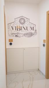 a white room with a clock on the wall at VIBINUM Bed & Breakfast in Bovino