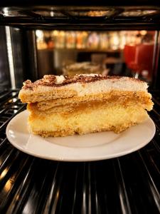 a piece of cake on a plate in an oven at Zajazd Alicja in Nowe Bagienice