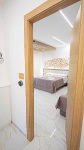 a large room with two beds and a mirror at VIBINUM Bed & Breakfast in Bovino