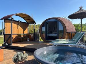 a gazebo and a hot tub on a deck at Tonn'O'Trip in Puy-lʼÉvêque
