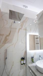 a bathroom with a shower and a sink and a mirror at VIBINUM Bed & Breakfast in Bovino +33 photos