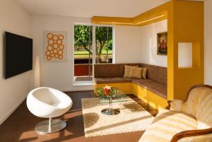 a living room with a couch and a table at Sun Matrei Apartments in Matrei in Osttirol