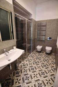 a bathroom with a sink and a shower and a toilet at Le Dimax in Sant'Agnello +23 photos