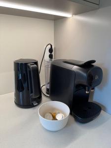 a coffee maker and a bowl of eggs on a counter at Parkside apartment in Narvik