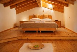 a bedroom with a bed with a hat on it at Sun Matrei Apartments in Matrei in Osttirol
