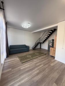 a living room with a couch and a staircase at Lake in Bosteri