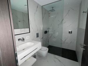 a bathroom with a sink and a toilet and a mirror at Nordis 20 Deluxe Room Mamaia Nord in Mamaia Sat/Năvodari