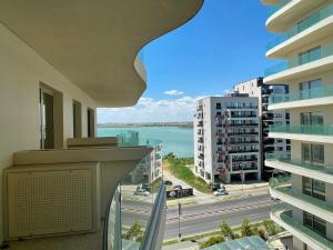 a balcony with a view of the ocean and buildings at Nordis 20 Deluxe Room Mamaia Nord in Mamaia Sat/Năvodari +12 photos