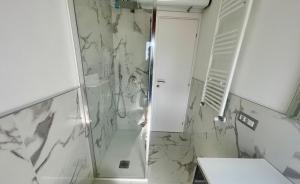 a bathroom with a shower and a toilet at Moderno Bilocale Bresso in Bresso +7 photos