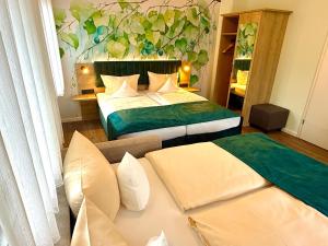 a hotel room with two beds and a couch at Ambient Hotel am Europakanal in Fürth +137 photos