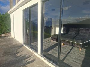 a room with a bed on a porch with sliding glass doors at Alojamiento Campestre Barachel in Pamplona