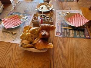 a plate of bread and pastries on a wooden table at L'écho des Artois in Uzelle