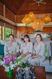 a group of three women sitting on a couch at Villa Ayundra in Lipa Noi +111 photos