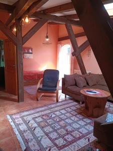 a living room with a couch and a table at Ferien am Schloss - Wohnung 6 "der Pferdestall", Ferienwohnung am Badesee in Behren-Lübchin
