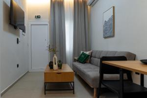 a living room with a couch and a table at Annasa Suites 1 in Mángana