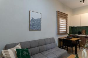 a living room with a couch and a table at Annasa Suites 1 in Mángana