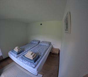 a small bedroom with a bed with towels on it at Una Bliss in Kulen Vakuf
