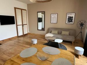 a living room with two tables and a couch at Molène Centre Ville Lannion in Lannion