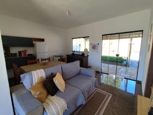 a living room with a couch with pillows on it at Recanto da Nonô in Gonçalves