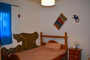 a bedroom with a bed with a wooden bed frame at Casa de desierto in Tabernas +65 photos