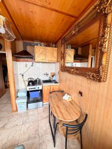 a small kitchen with a wooden table and a stove at Mieszkanie Pod Sztolniami- Riese in Walim
